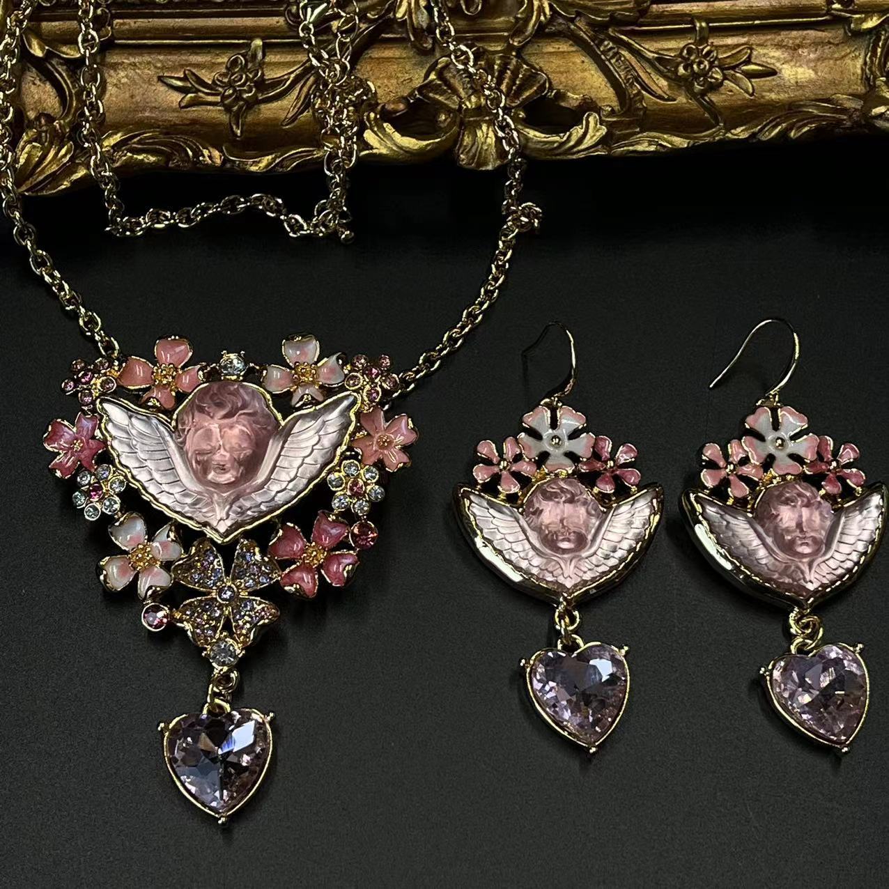 Vibrant jewelry set with pink gemstones and angelic designs, vintage jewelry, vintage necklace, vintage earrings